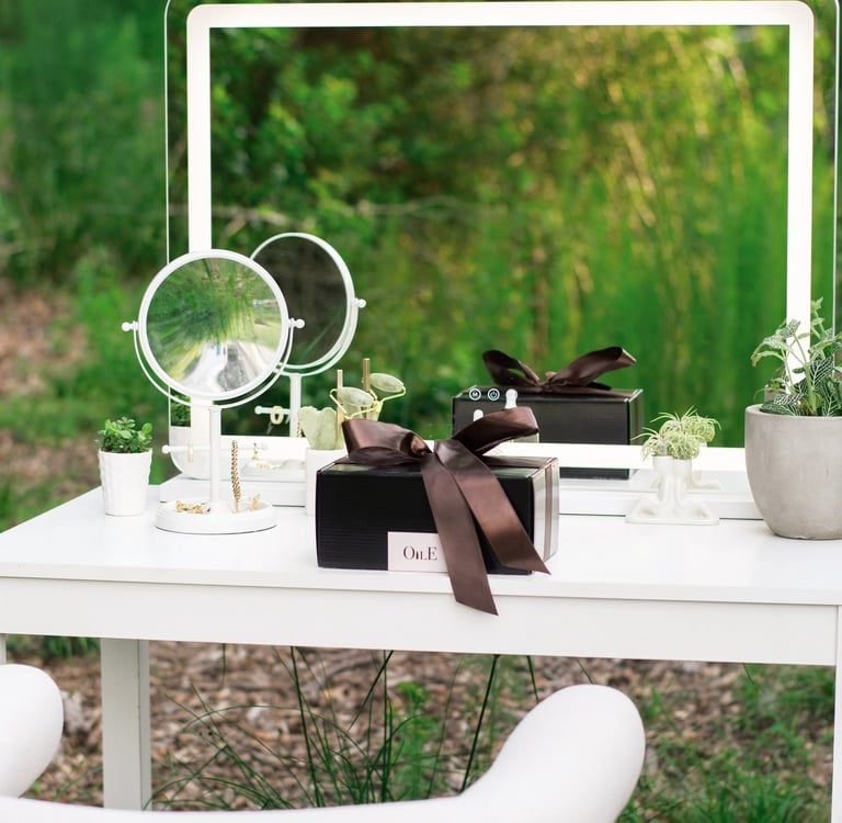 A modern outdoor vanity table with LED makeup mirrors, luxury gift boxes, and jewelry accessories.