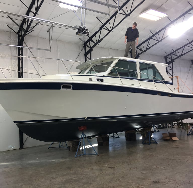 a man standing on a boat in a warehouse