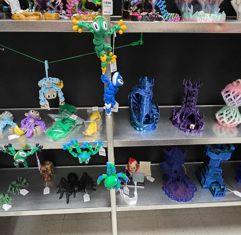 A retail shelf display featuring colorful 3D printed toys, articulated monkeys, and fantasy dice towers.
