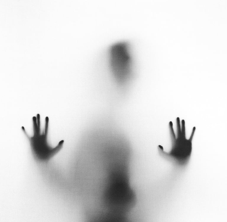 Eerie blurry silhouette of a person pressing their hands against a frosted glass surface.