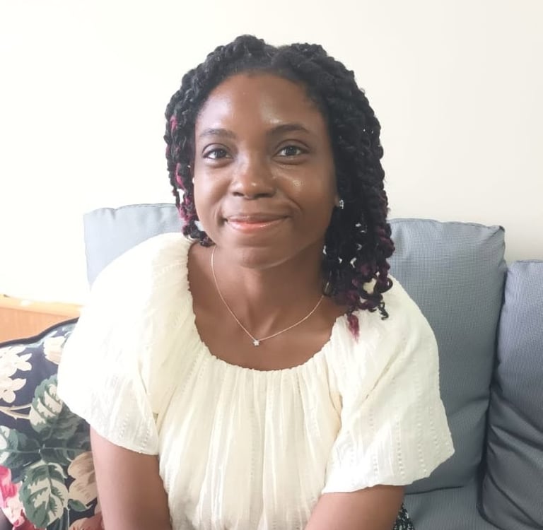 woman smiling with grey chair background