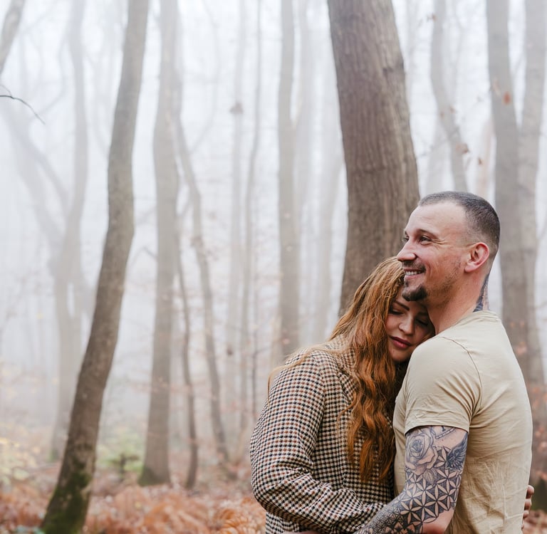 couple qui s'enlacent en forêt lumière froide brume