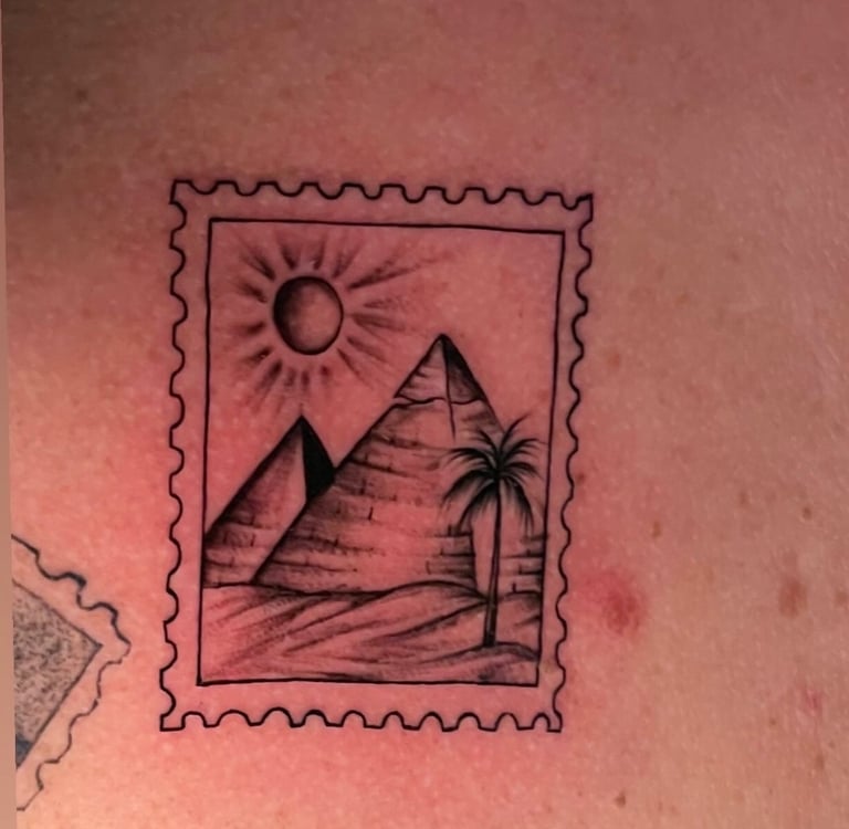 Pyramid tattoo on arm fin line—hurghada tattoo studio 