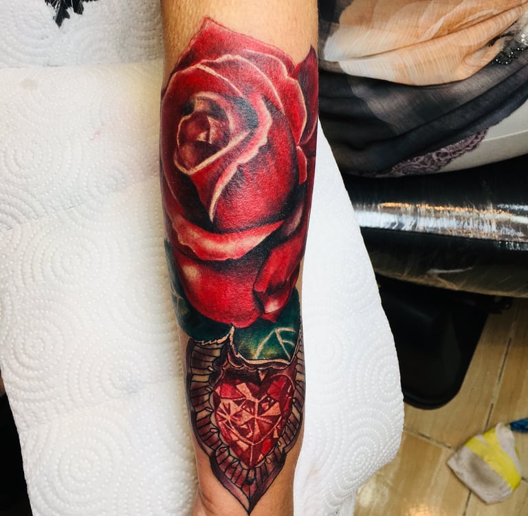 Rose tattoo in colouring on forearm — Hurghada Tattoo Studio