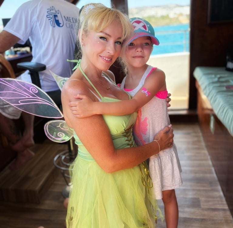 Fairy performer with a child guest on a family boat tour in Cyprus