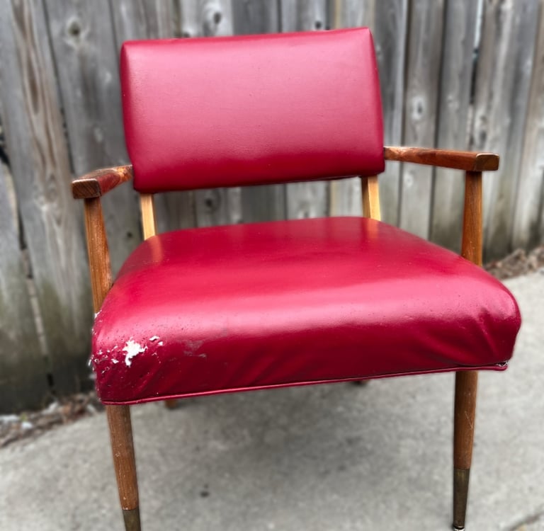 red vinyl vintage chair with edge damage