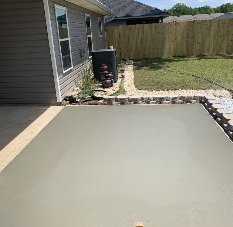Custom concrete patio installation with clean finish and decorative border design