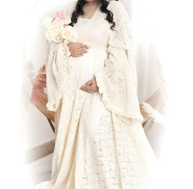 pregnant woman highlighting her baby bump against a studio backdrop.