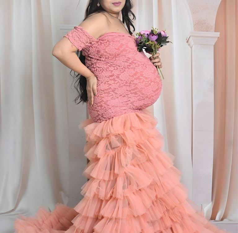 pregnant woman highlighting her baby bump against a studio backdrop.