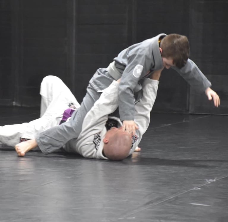 coach training child in bjj