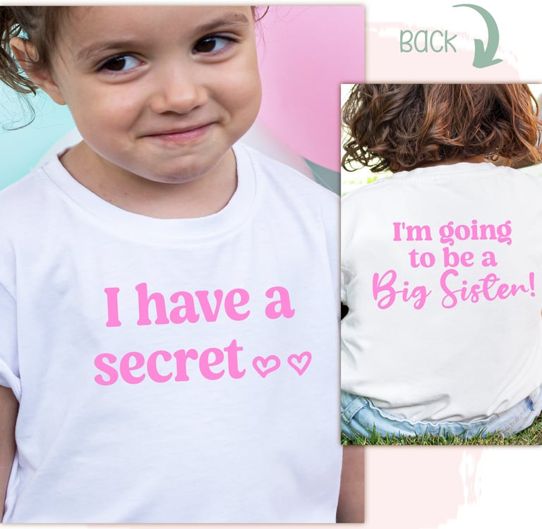 little girl wearing a white shirt with pink letters & "I have a secret I'm going to be a Big Sister"