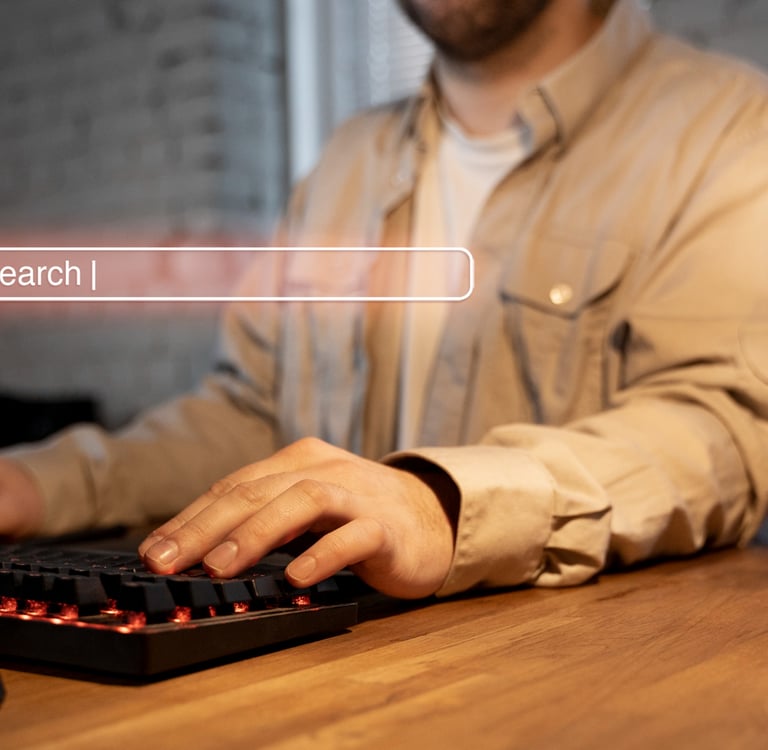 a man sitting at a desk with a keyboard and a keyboard