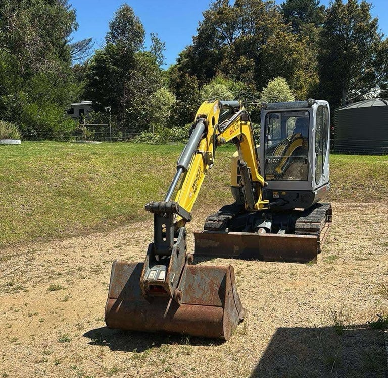 Compact 6 tonne Wacker Neuson excavator with digging buckets – used for test pits