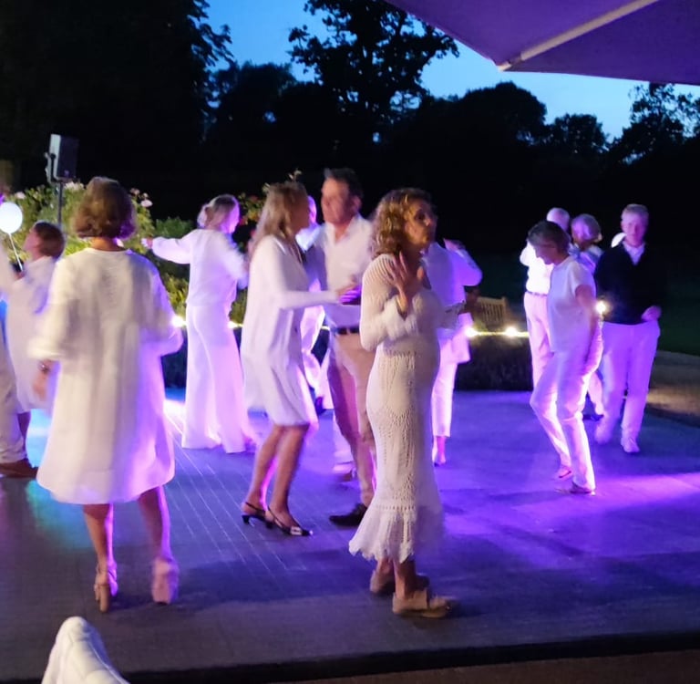 a group of people standing around a table with drinks