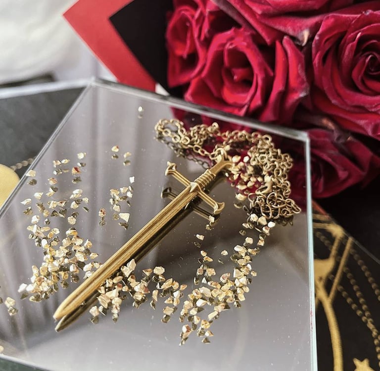 a gold sword accessory on a table