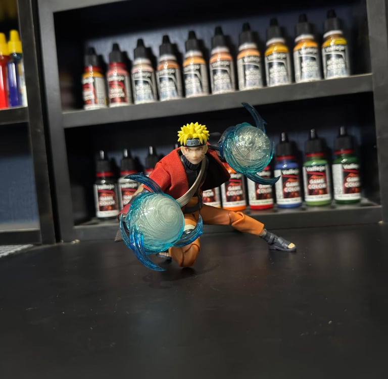 Naruto Uzumaki Sage Mode action figure posing with Rasengan effects in front of Vallejo paint bottles.