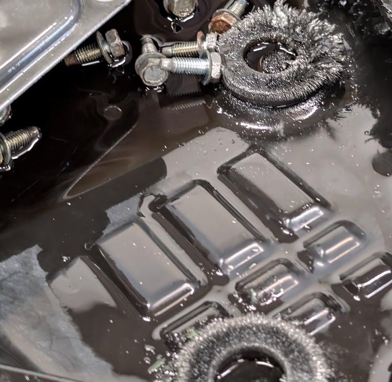 Metal shavings on transmission pan magnets during an oil change and gearbox inspection.