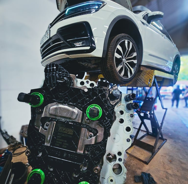 A white Volkswagen Tiguan on a hydraulic lift in a repair shop with a DQ381 mechatronic unit