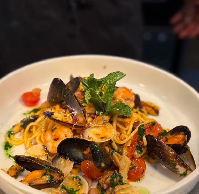 a plate of pasta with musselling and musselling