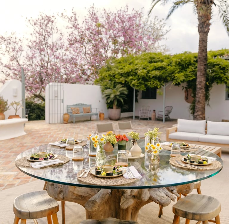 Courtyard dining setting with flowers and Mediterranean details