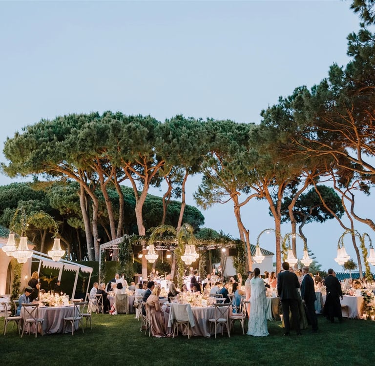 Evening gala dinner under chandeliers by the sea