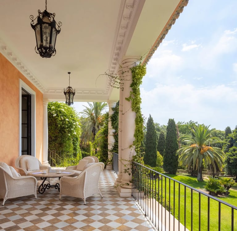 Shaded balcony terrace overlooking manicured palm gardens