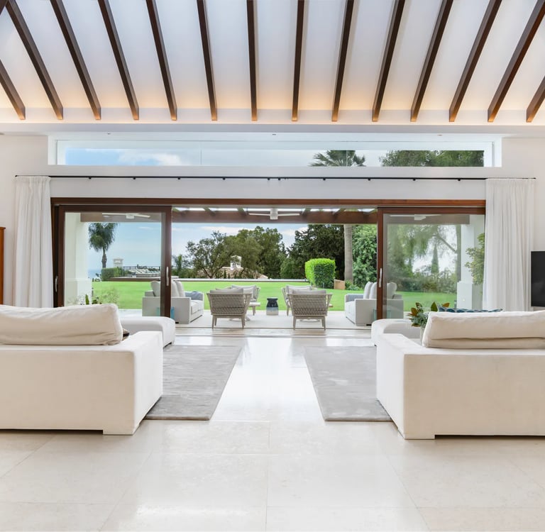 Open-plan living room with wood-beamed ceiling and sea views