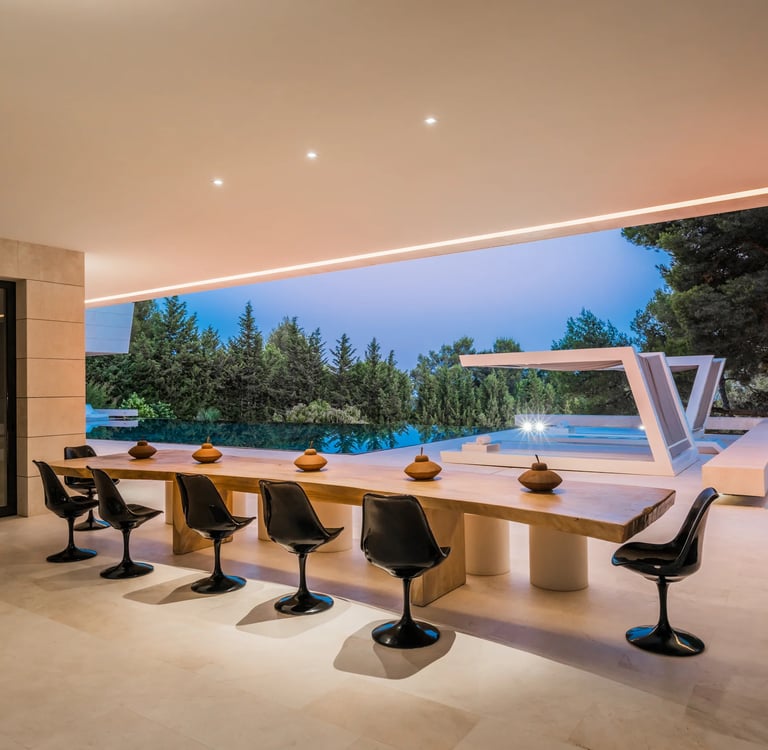 Covered outdoor dining terrace at dusk