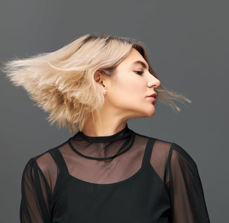 a woman with blonde hair and a black top