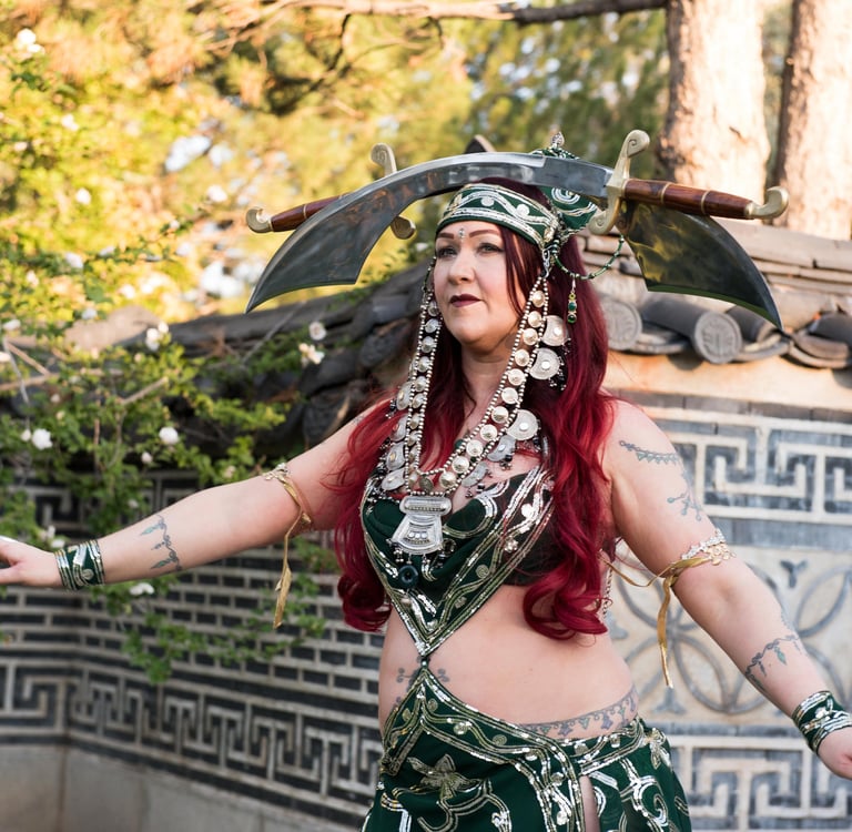 Double sword dancer Shaharvar in green costume performing at temple