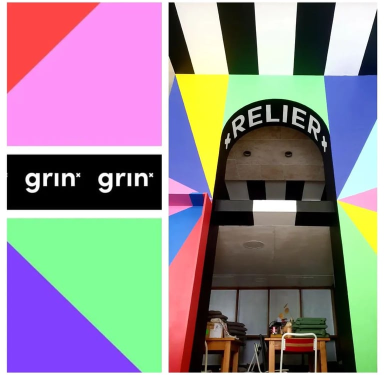 une fresque avec des triangles de couleurs vives et des inscriptions noir et blanches