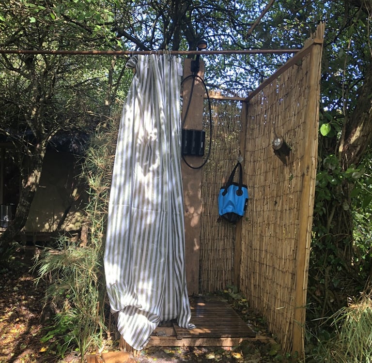 bamboo constructed outdoor shower set in woodland
