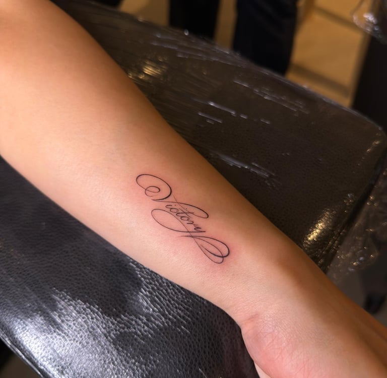 Fine line cursive lettering tattoo on arm – Sinkply Zürich