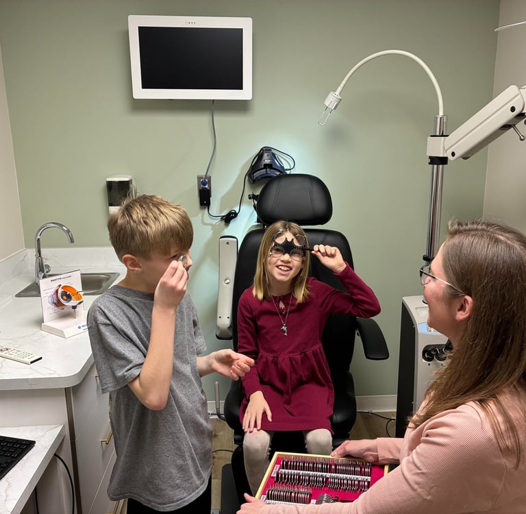 Young patients enjoying a pediatric eye exam at a Southborough clinic