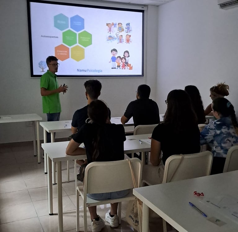 a man standing in front of a classroom with a projector