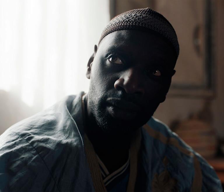 a man with a hat and a blue shirt