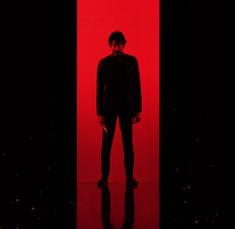 a man in a batman costume is standing in front of a store