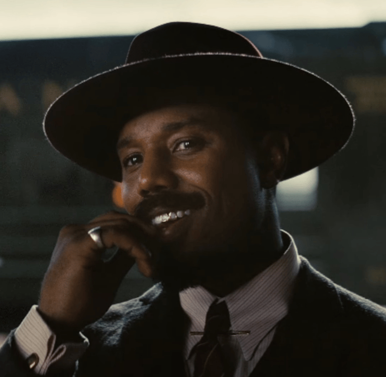 a man in a suit and tie is talking on a cell phone