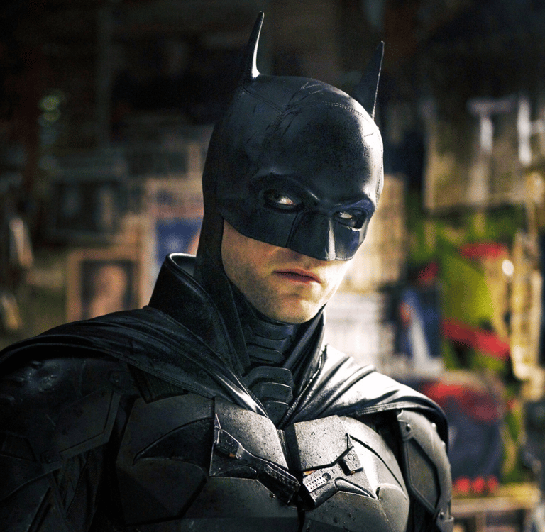 a man in a suit and hat holding a hat