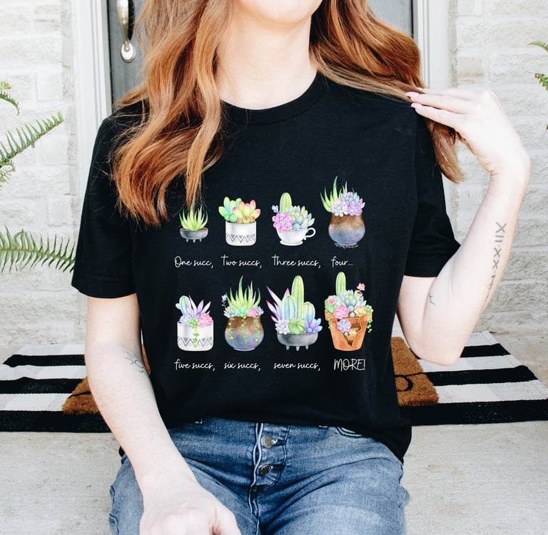 Girl wearing black succulent graphic tee with multiple illustrated succulent pots across the front.