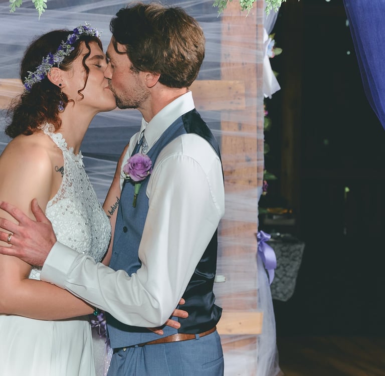 a bride and groom kissing in a wedding ceremony