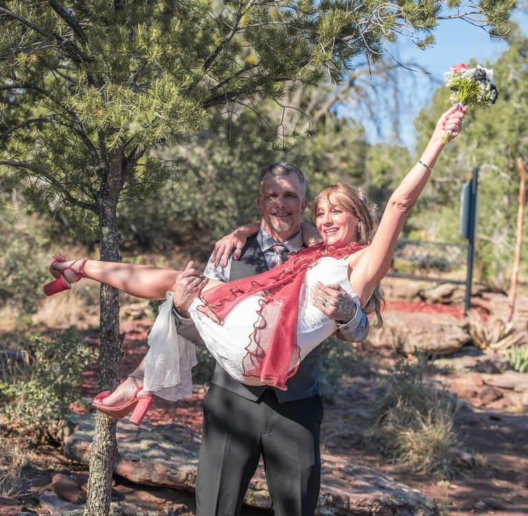a man and woman are holding a flower