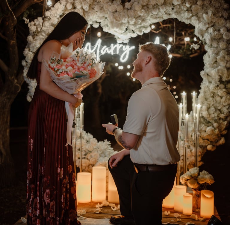 a man and woman standing in front of a wedding arch