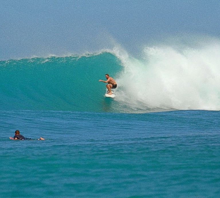 a man surfing on a wave in the ocean