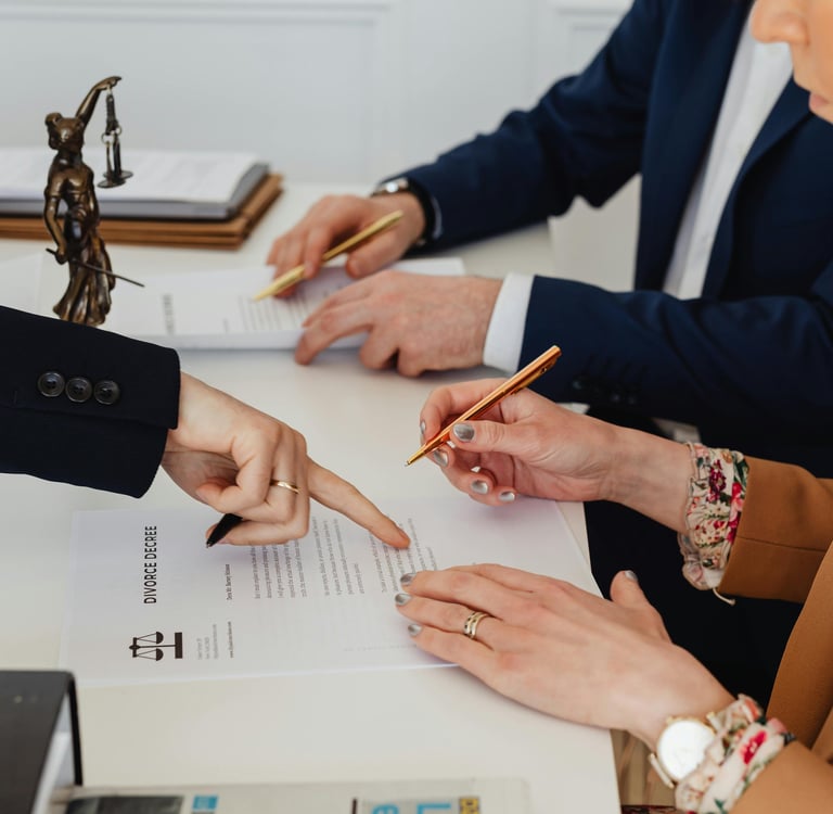 Couple signing divorce papers in a lawyers office dissolving their marriage