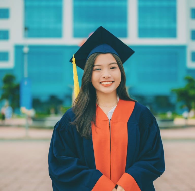 young woman dressed in graduation cap and gown heading into a life transition