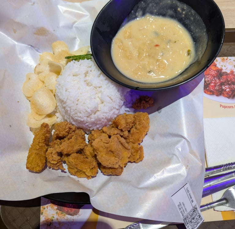 Crispy salted egg chicken popcorn served with steamed white rice, crackers, and creamy sauce.