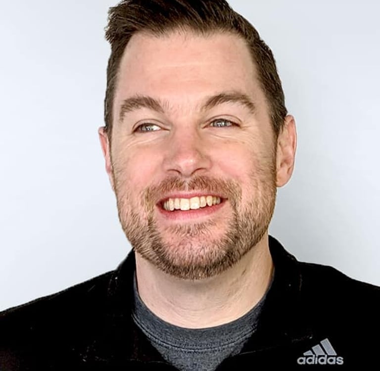 Damon Gaumont, a man with a beard wearing a black polo over a grey shirt