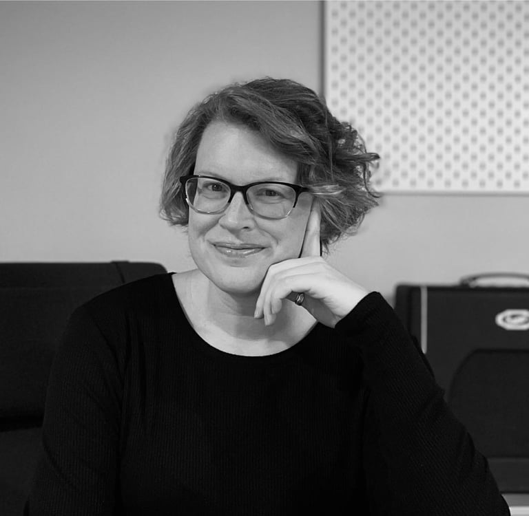 Mary Sherwin, a woman in glasses and a black sweater