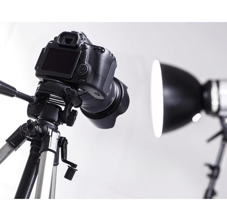 a camera and a light on a tripod